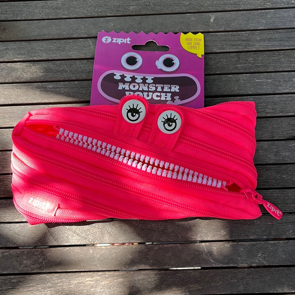 Monster Pouch has bright white eyes with matching bright white teeth BNWT
